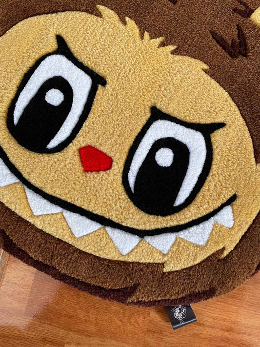 Labubu face area rug close-up: yellow fur, brown outlines, red heart