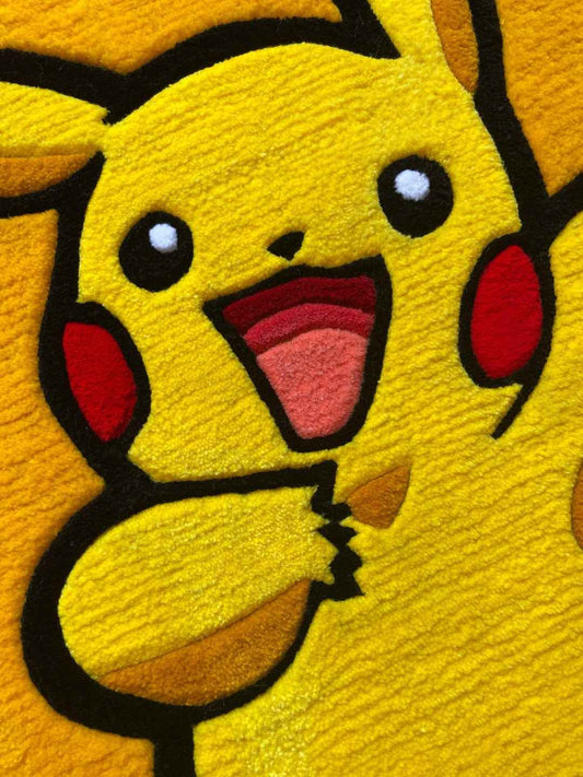 Close-up Pikachu rug face: big round eyes, pink tongue, and red cheek circles on yellow