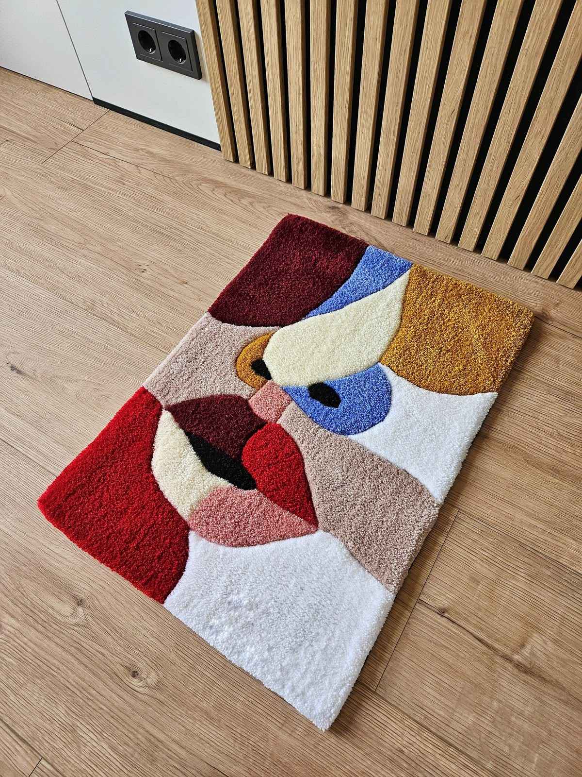 Abstract multicolor area rug with geometric shapes in red, blue, beige, and white