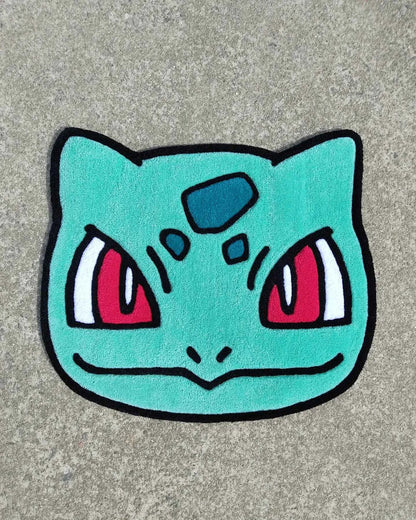 Bulbasaur head rug, turquoise face with red eyes and black outline border