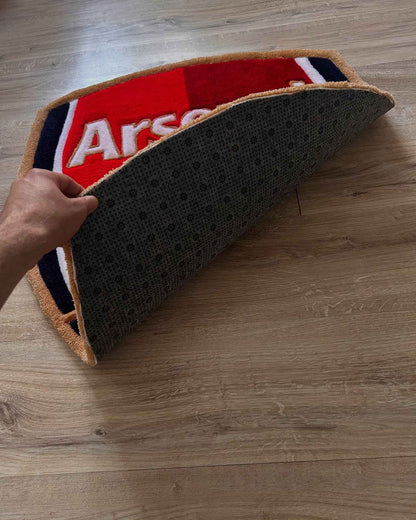 Arsenal shield rug with textured dark backing and gold edge trim